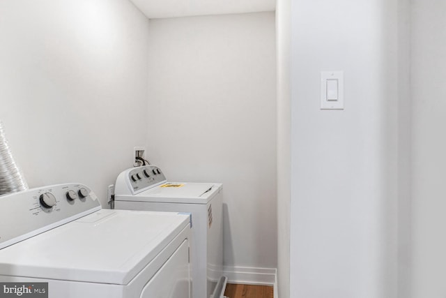 3402 Halloway S, Upper Marlboro, MD 20772 - laundry room featuring washing machine and dryer, baseboards, and wood finished floors