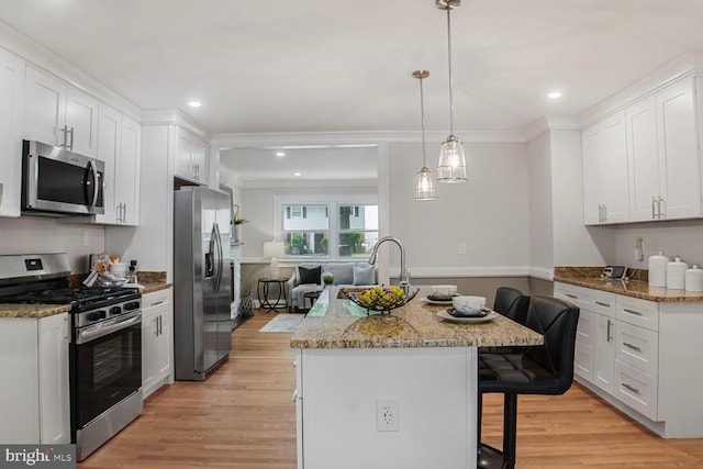 3402 Halloway S, Upper Marlboro, MD 20772 - kitchen featuring stainless steel appliances, ornamental molding, a breakfast bar area, white cabinetry, and light wood-type flooring