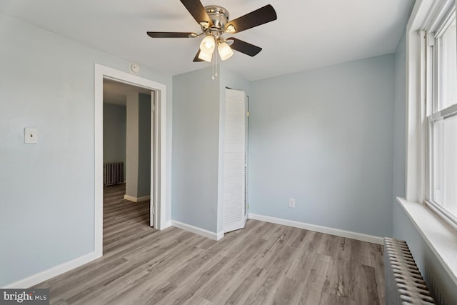635 Elroy Rd, Souderton, PA 18964 - unfurnished bedroom featuring radiator heating unit, wood finished floors, baseboards, and a ceiling fan