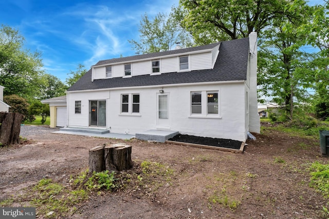 635 Elroy Rd, Souderton, PA 18964 - back of property with an attached garage, a chimney, a shingled roof, and driveway