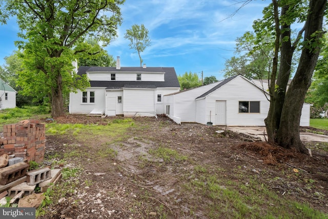 635 Elroy Rd, Souderton, PA 18964 - rear view of property with a shingled roof and a chimney