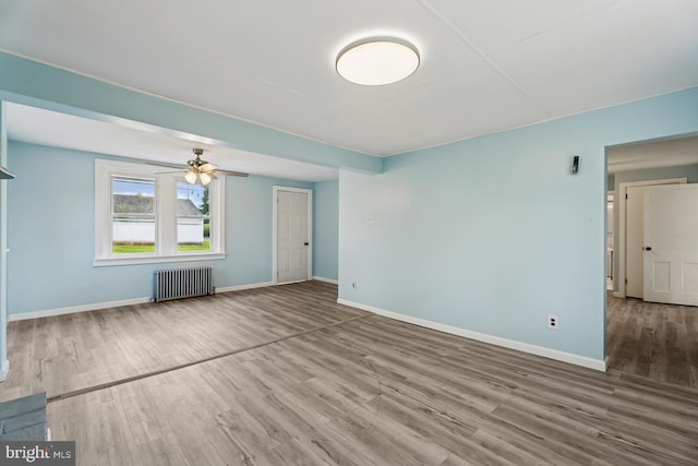 635 Elroy Rd, Souderton, PA 18964 - unfurnished living room with radiator heating unit, wood finished floors, baseboards, and ceiling fan