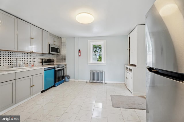 635 Elroy Rd, Souderton, PA 18964 - kitchen featuring stainless steel appliances, radiator heating unit, gray cabinets, and light marble finish flooring