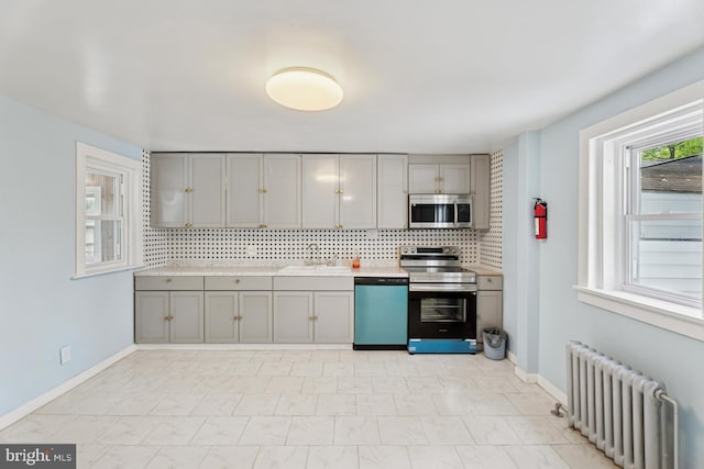635 Elroy Rd, Souderton, PA 18964 - kitchen featuring radiator, appliances with stainless steel finishes, gray cabinets, decorative backsplash, and baseboards