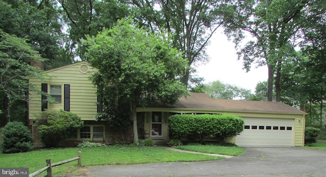 12060 Willowood Dr, Woodbridge, VA 22192 - tri-level home featuring driveway, a garage, and a front lawn