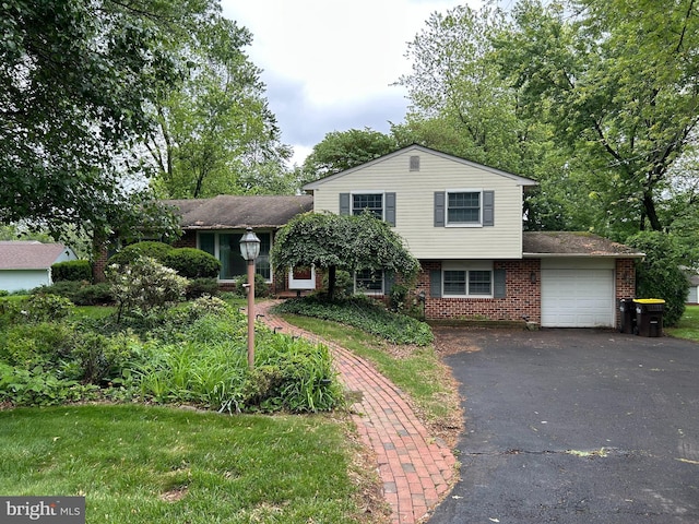 1541 Moyer Rd, Hatfield, PA 19440 - tri-level home featuring an attached garage, brick siding, and asphalt driveway