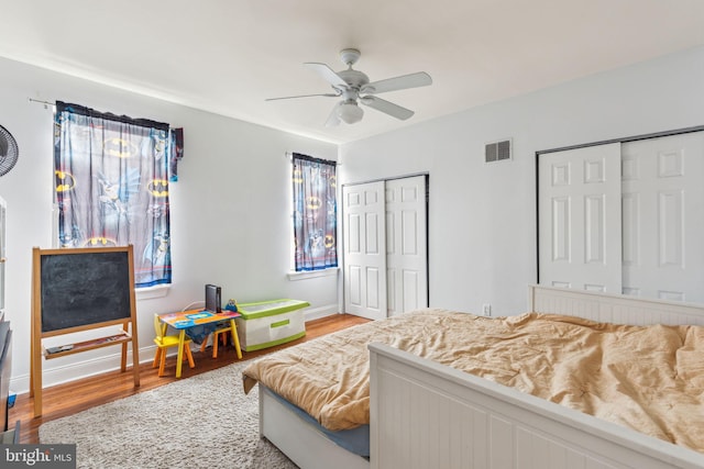 766 S 18th St, Philadelphia, PA 19146 - bedroom featuring two closets, wood finished floors, baseboards, and a ceiling fan