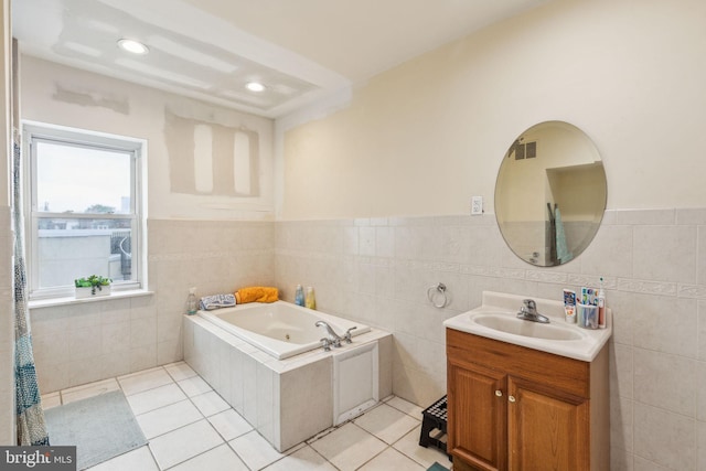 766 S 18th St, Philadelphia, PA 19146 - full bathroom featuring vanity, a tub with jets, tile patterned floors, tile walls, and wainscoting
