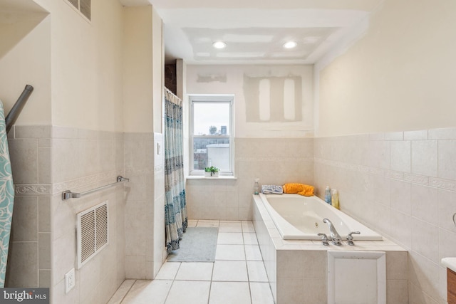 766 S 18th St, Philadelphia, PA 19146 - full bathroom featuring tile walls, a garden tub, tile patterned floors, wainscoting, and a shower with curtain
