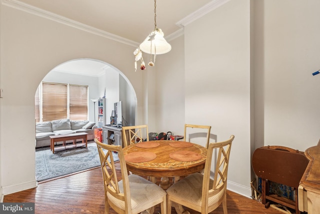 766 S 18th St, Philadelphia, PA 19146 - dining area featuring crown molding, wood finished floors, arched walkways, and baseboards
