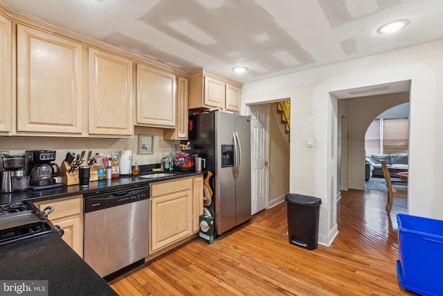 766 S 18th St, Philadelphia, PA 19146 - kitchen featuring stainless steel appliances, light brown cabinetry, light wood finished floors, dark countertops, and recessed lighting