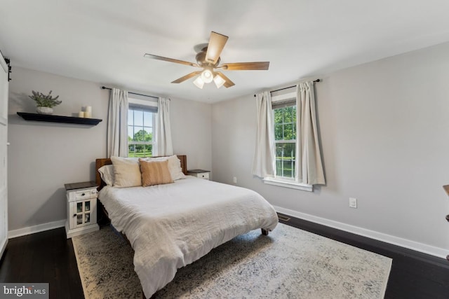 927 Annapolis Rd, Gambrills, MD 21054 - bedroom featuring multiple windows, baseboards, dark wood-style floors, and ceiling fan