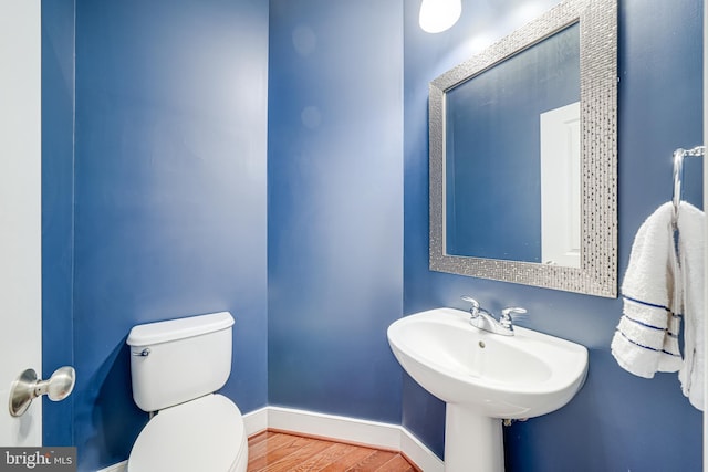 585 Regent Pl NE, Washington, DC 20017 - bathroom with toilet, wood finished floors, and baseboards
