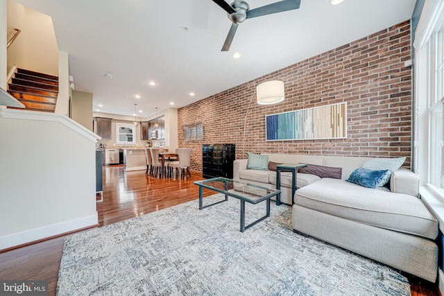 585 Regent Pl NE, Washington, DC 20017 - living room featuring brick wall, stairway, wood finished floors, recessed lighting, and a ceiling fan