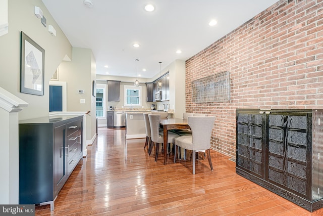 585 Regent Pl NE, Washington, DC 20017 - dining room with light wood-style floors, brick wall, and recessed lighting