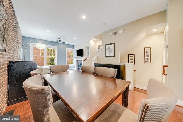 585 Regent Pl NE, Washington, DC 20017 - dining space featuring a glass covered fireplace, light wood-style floors, baseboards, ceiling fan, and recessed lighting