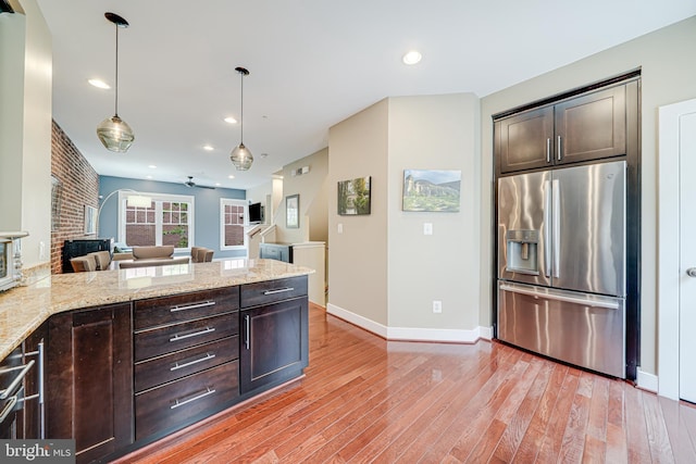 585 Regent Pl NE, Washington, DC 20017 - kitchen featuring stainless steel fridge with ice dispenser, dark brown cabinets, light wood finished floors, open floor plan, and a peninsula