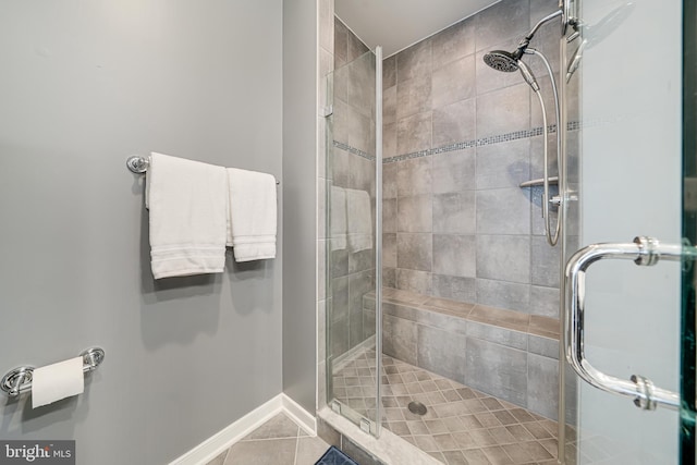 585 Regent Pl NE, Washington, DC 20017 - bathroom with a stall shower, tile patterned floors, and baseboards