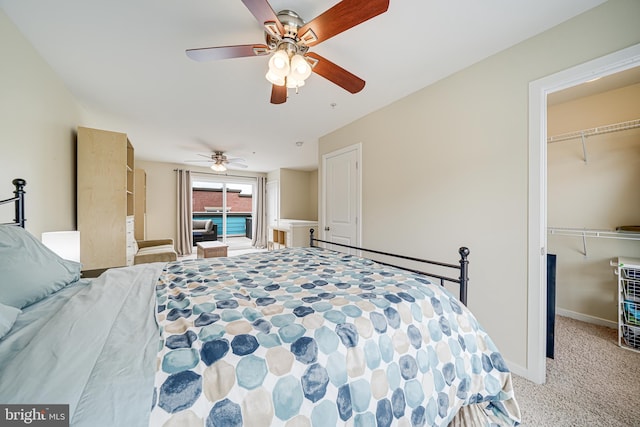 585 Regent Pl NE, Washington, DC 20017 - carpeted bedroom with a walk in closet, a closet, baseboards, and ceiling fan