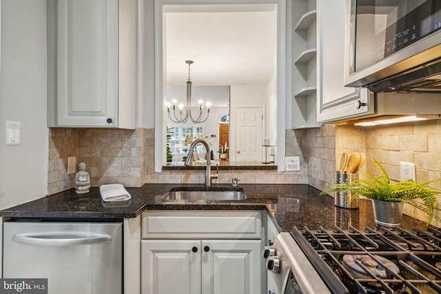 314 Monroe St, Philadelphia, PA 19147 - kitchen featuring appliances with stainless steel finishes, a sink, white cabinetry, a chandelier, and decorative backsplash