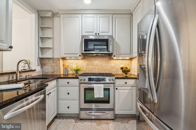 314 Monroe St, Philadelphia, PA 19147 - kitchen with stainless steel appliances, a sink, white cabinets, dark stone countertops, and recessed lighting