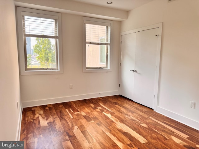 740 S Chris Columbus Blvd Unit 15, Philadelphia, PA 19147 - unfurnished bedroom featuring multiple windows, wood finished floors, and a closet