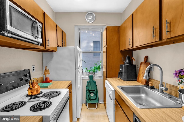 1725 New Hampshire Ave NW Unit 303, Washington, DC 20009 - kitchen with white appliances, a sink, light countertops, and brown cabinetry