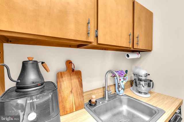 1725 New Hampshire Ave NW Unit 303, Washington, DC 20009 - kitchen view of a sink, light countertops, and brown cabinetry