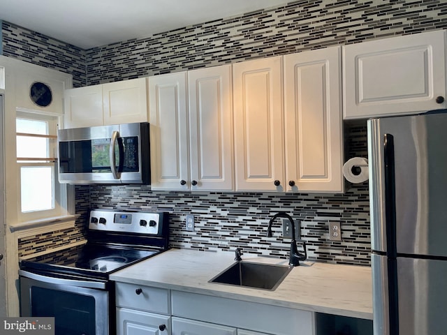 3401 Commonwealth Ave Unit A, Alexandria, VA 22305 - kitchen with appliances with stainless steel finishes, a sink, backsplash, and white cabinets