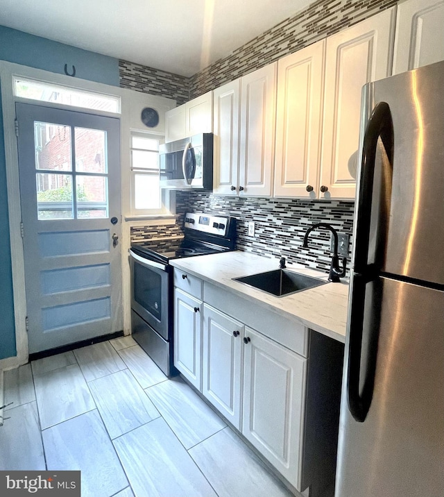 3401 Commonwealth Ave Unit A, Alexandria, VA 22305 - kitchen with appliances with stainless steel finishes, a sink, and white cabinets