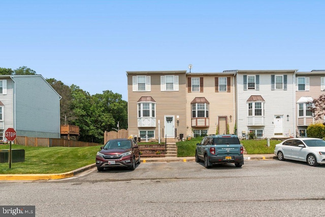 410 Kosoak Rd, Baltimore, MD 21220 - townhome / multi-family property with uncovered parking and a front lawn