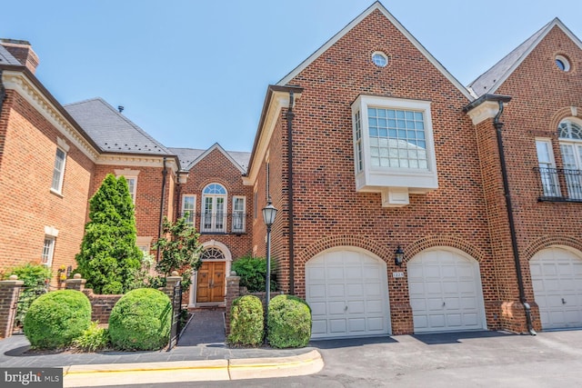 1225 Stuart Robeson Dr, Mclean, VA 22101 - view of front of home featuring brick siding, a garage, and driveway