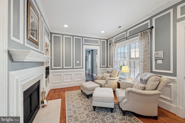 1225 Stuart Robeson Dr, Mclean, VA 22101 - living area with a decorative wall, ornamental molding, a fireplace with flush hearth, wood finished floors, and recessed lighting