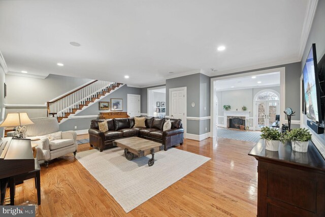 1225 Stuart Robeson Dr, Mclean, VA 22101 - living area with stairs, crown molding, a fireplace, light wood-style floors, and recessed lighting