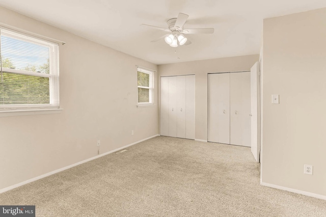2053 Wintergreen Pl, Rosedale, MD 21237 - unfurnished bedroom with two closets, carpet floors, baseboards, and a ceiling fan