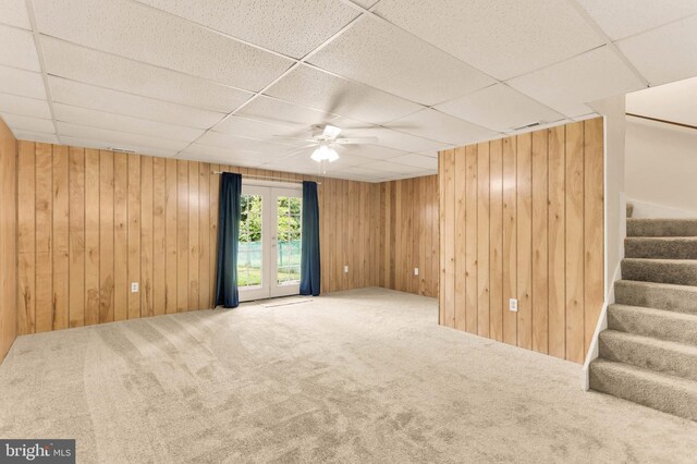 2053 Wintergreen Pl, Rosedale, MD 21237 - carpeted spare room with a drop ceiling, stairway, wooden walls, and ceiling fan