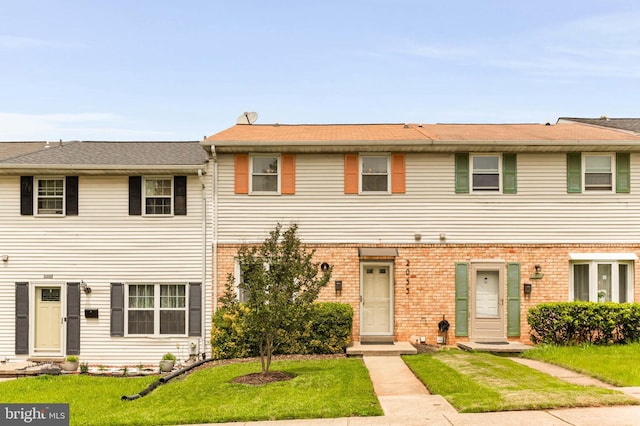 2053 Wintergreen Pl, Rosedale, MD 21237 - townhome / multi-family property with a front lawn and brick siding