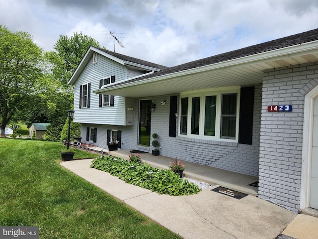 1423 Hallowell Ln, New Windsor, MD 21776 - tri-level home featuring brick siding, a front lawn, and covered porch