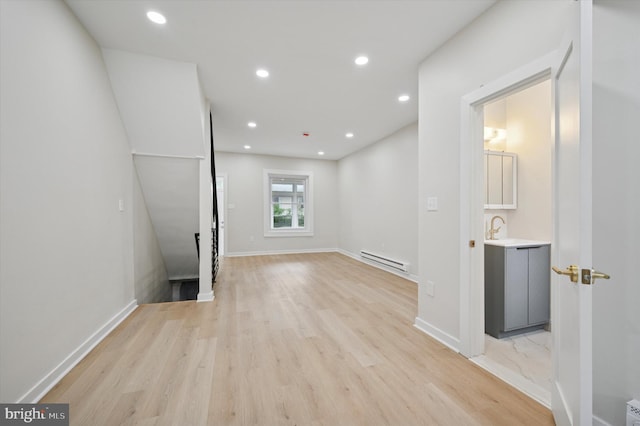46 E Price St, Philadelphia, PA 19144 - empty room featuring a baseboard heating unit, light wood-style floors, recessed lighting, baseboards, and a sink