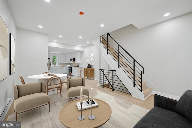 46 E Price St, Philadelphia, PA 19144 - living area featuring stairway, light wood-type flooring, baseboards, recessed lighting, and a baseboard heating unit