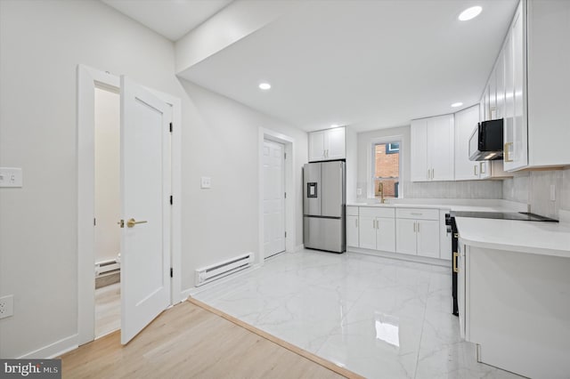 46 E Price St, Philadelphia, PA 19144 - kitchen with stainless steel fridge with ice dispenser, a baseboard heating unit, a sink, white cabinets, and light countertops
