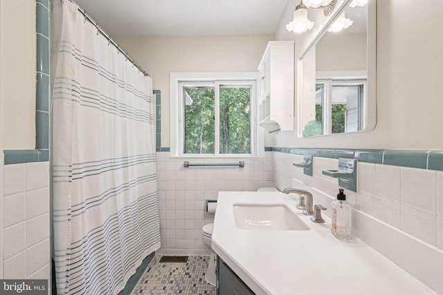 9307 Overlea Dr, Rockville, MD 20850 - full bathroom featuring tile walls, vanity, tile patterned floors, toilet, and a wainscoted wall