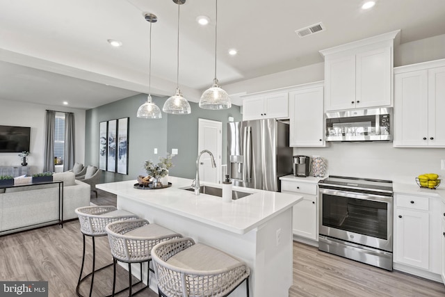 351 Anthem St, Ranson, WV 25438 - kitchen featuring appliances with stainless steel finishes, a sink, light countertops, light wood-style flooring, and white cabinetry