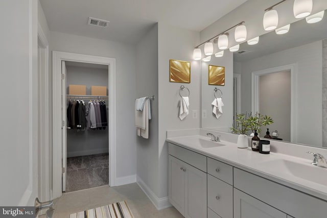 351 Anthem St, Ranson, WV 25438 - bathroom with double vanity, a spacious closet, baseboards, and tile patterned flooring