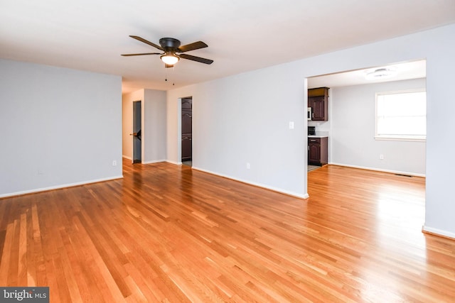 10903 Exeter Ct, Upper Marlboro, MD 20774 - empty room featuring light wood-style floors, a ceiling fan, and baseboards
