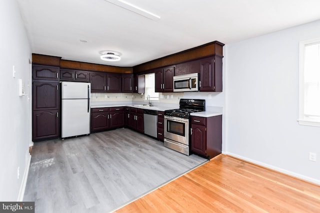 10903 Exeter Ct, Upper Marlboro, MD 20774 - kitchen featuring stainless steel appliances, light wood-style floors, light countertops, and dark brown cabinets