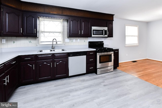 10903 Exeter Ct, Upper Marlboro, MD 20774 - kitchen with stainless steel appliances, a sink, light wood finished floors, and light countertops