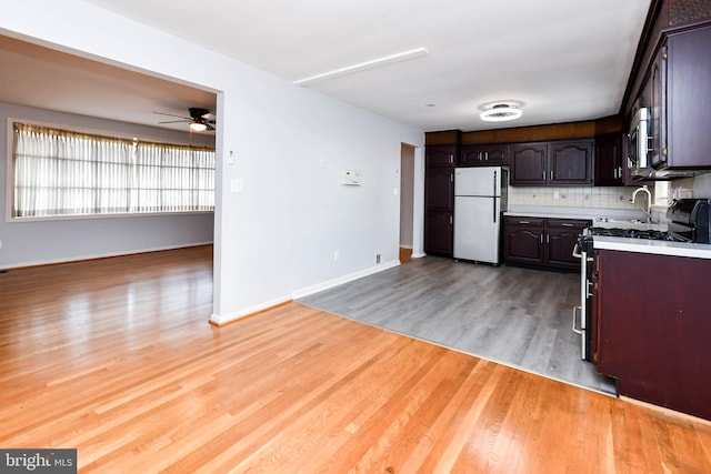 10903 Exeter Ct, Upper Marlboro, MD 20774 - kitchen featuring freestanding refrigerator, range with gas stovetop, a ceiling fan, light wood finished floors, and open floor plan