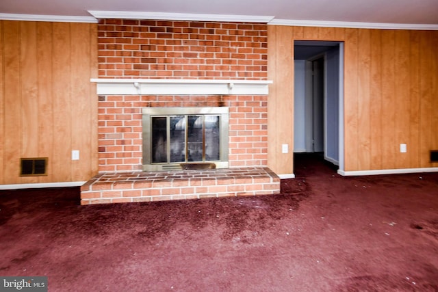 10903 Exeter Ct, Upper Marlboro, MD 20774 - unfurnished living room featuring a fireplace, baseboards, carpet floors, wood walls, and crown molding