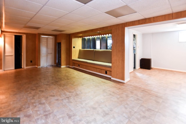 10903 Exeter Ct, Upper Marlboro, MD 20774 - empty room with a paneled ceiling, tile patterned floors, baseboards, and wood walls